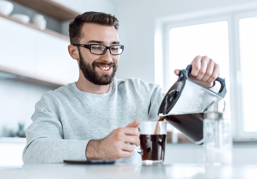 Man pouring himself black coffee
