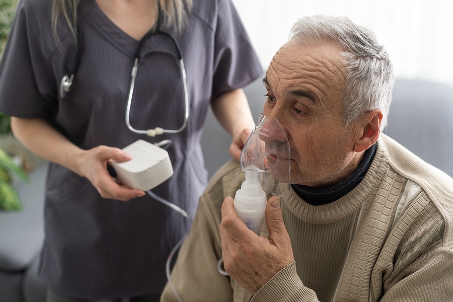 Man with a breathing nebuliser in a clinic setting